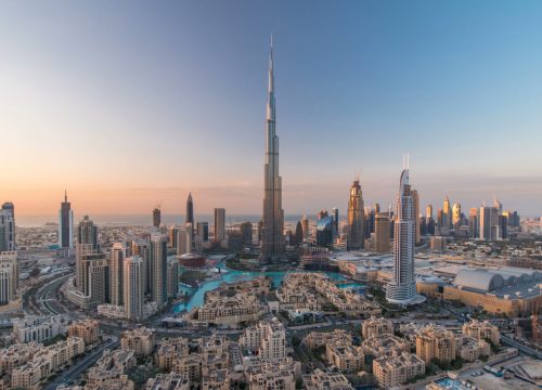 Dubai Downtown day to night transition timelapse with Burj Khalifa and other towers view from the top before new year celebration in Dubai, United Arab Emirates. Lights turning on.